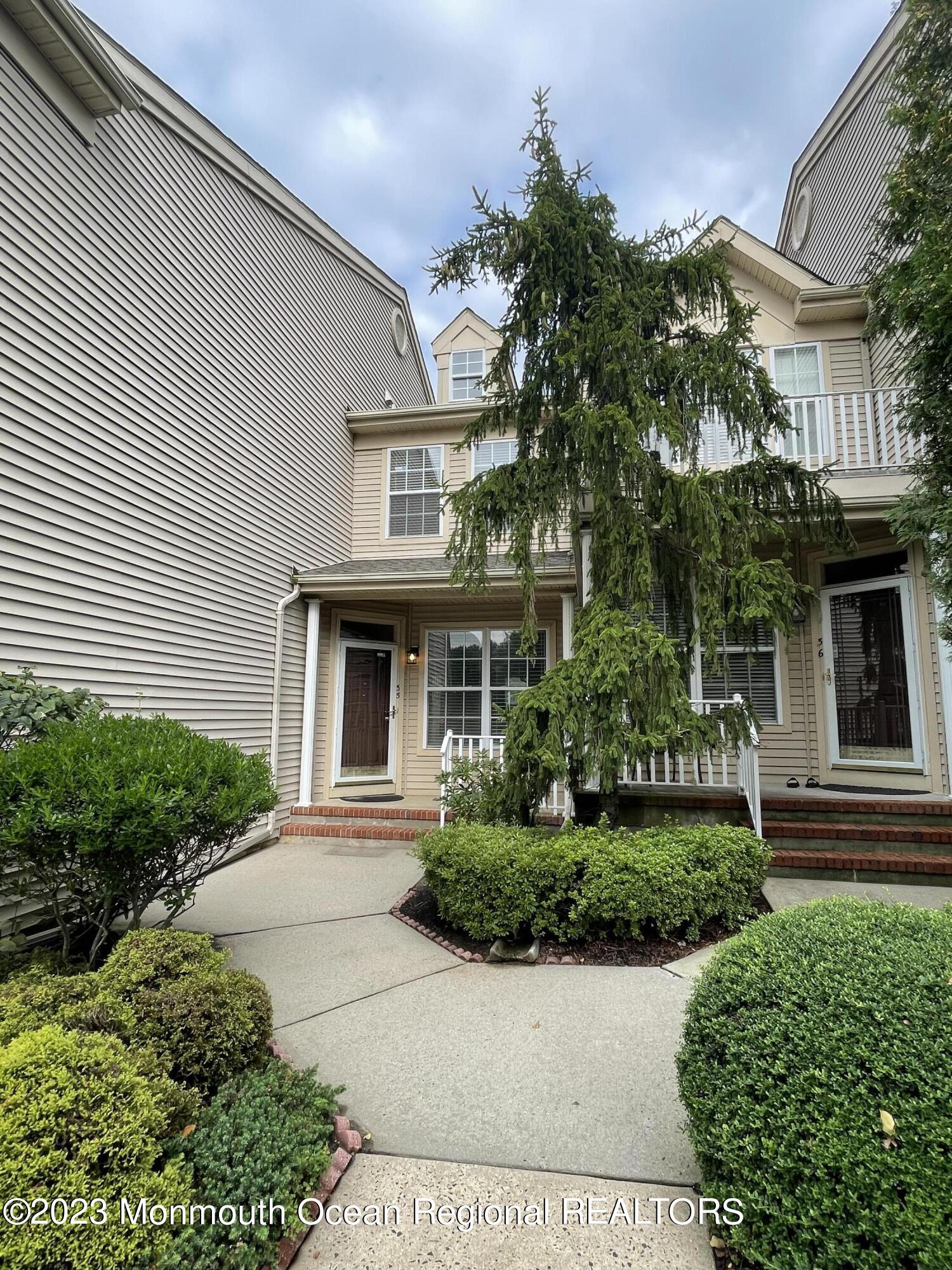 a front view of a house with a garden