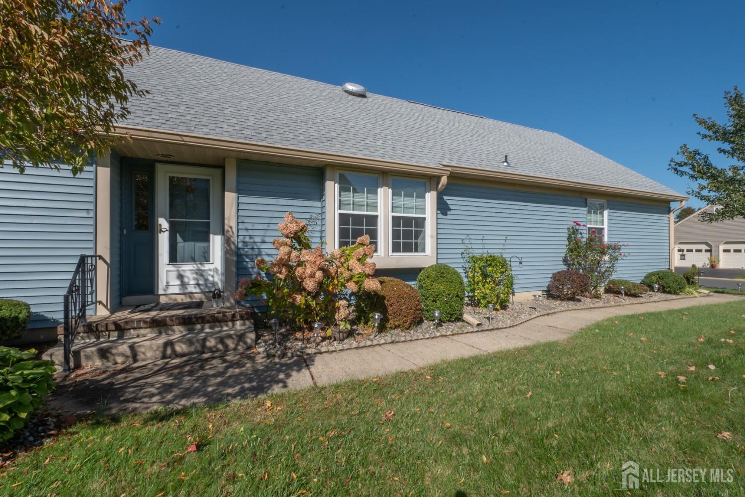 a front view of a house with a garden