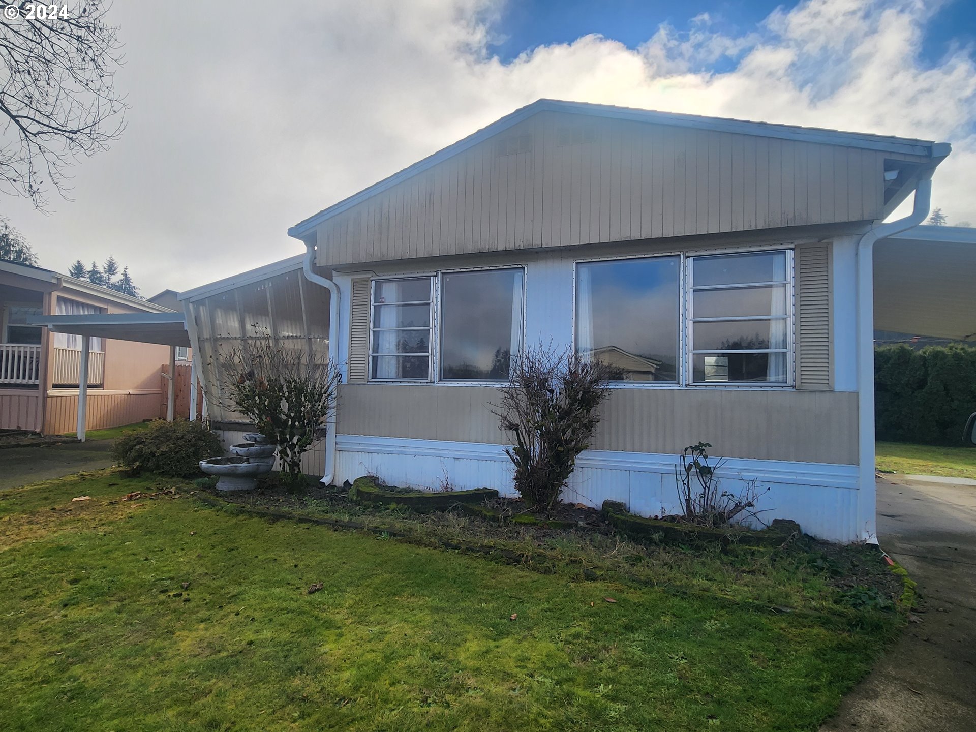 a front view of house with yard and outdoor seating