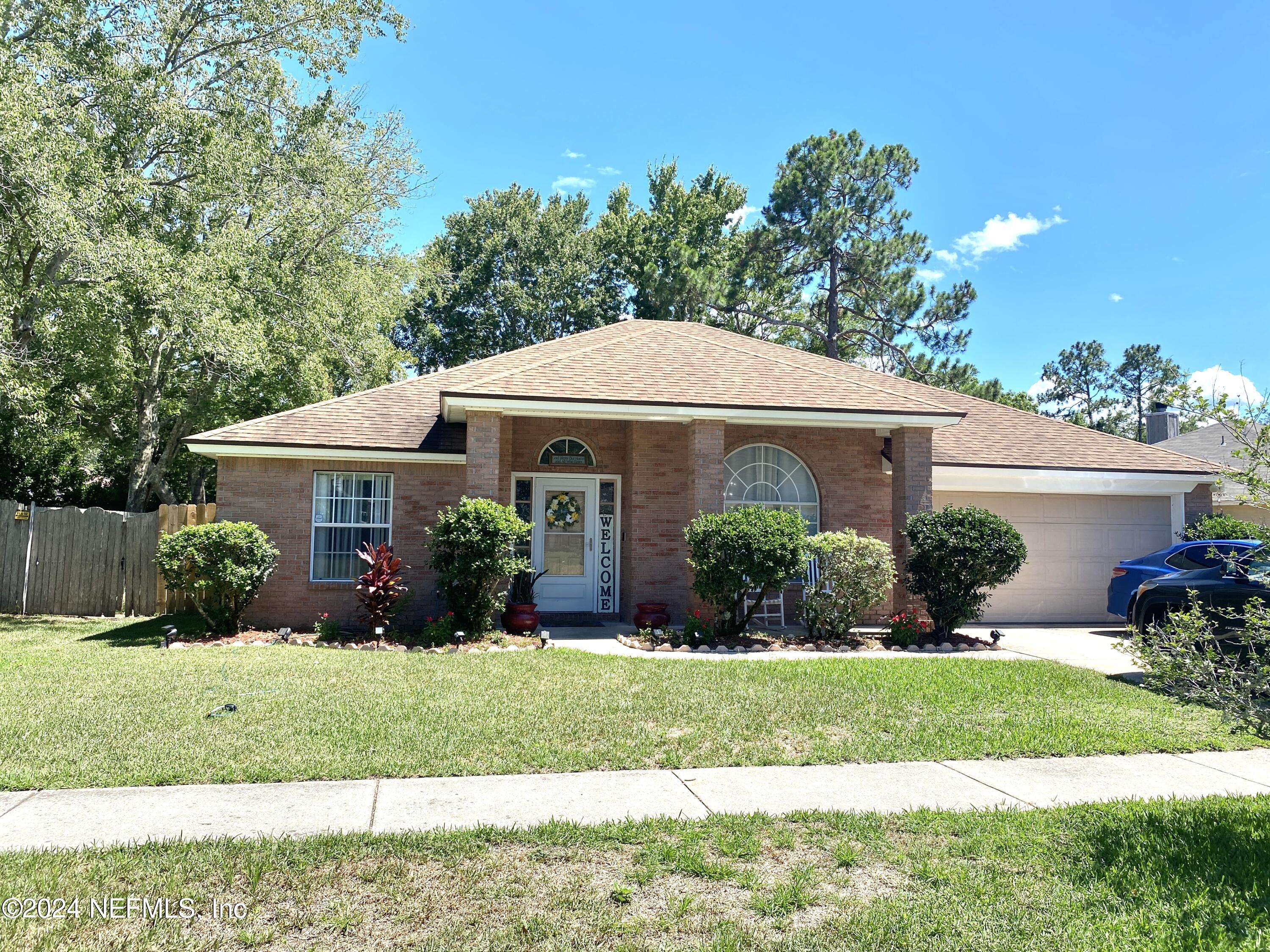 a front view of a house with a yard