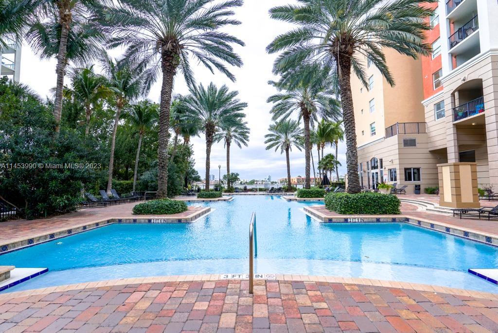 a view of swimming pool with outdoor seating and plants