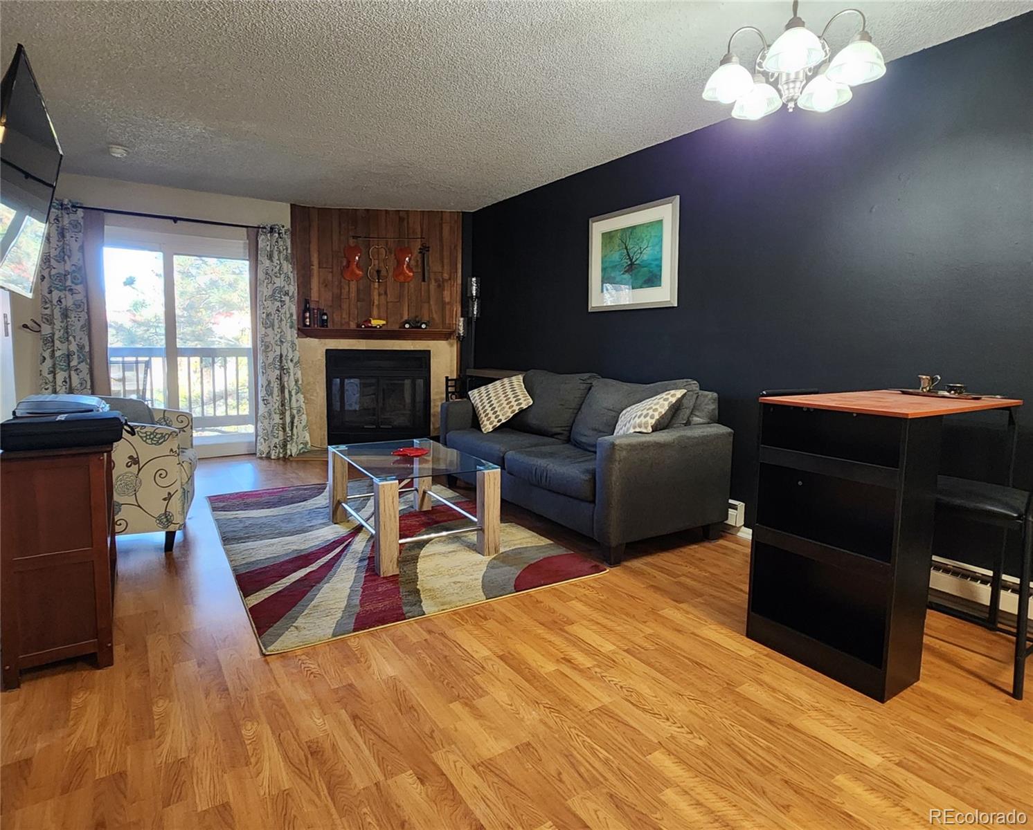 a living room with furniture a fireplace and a table