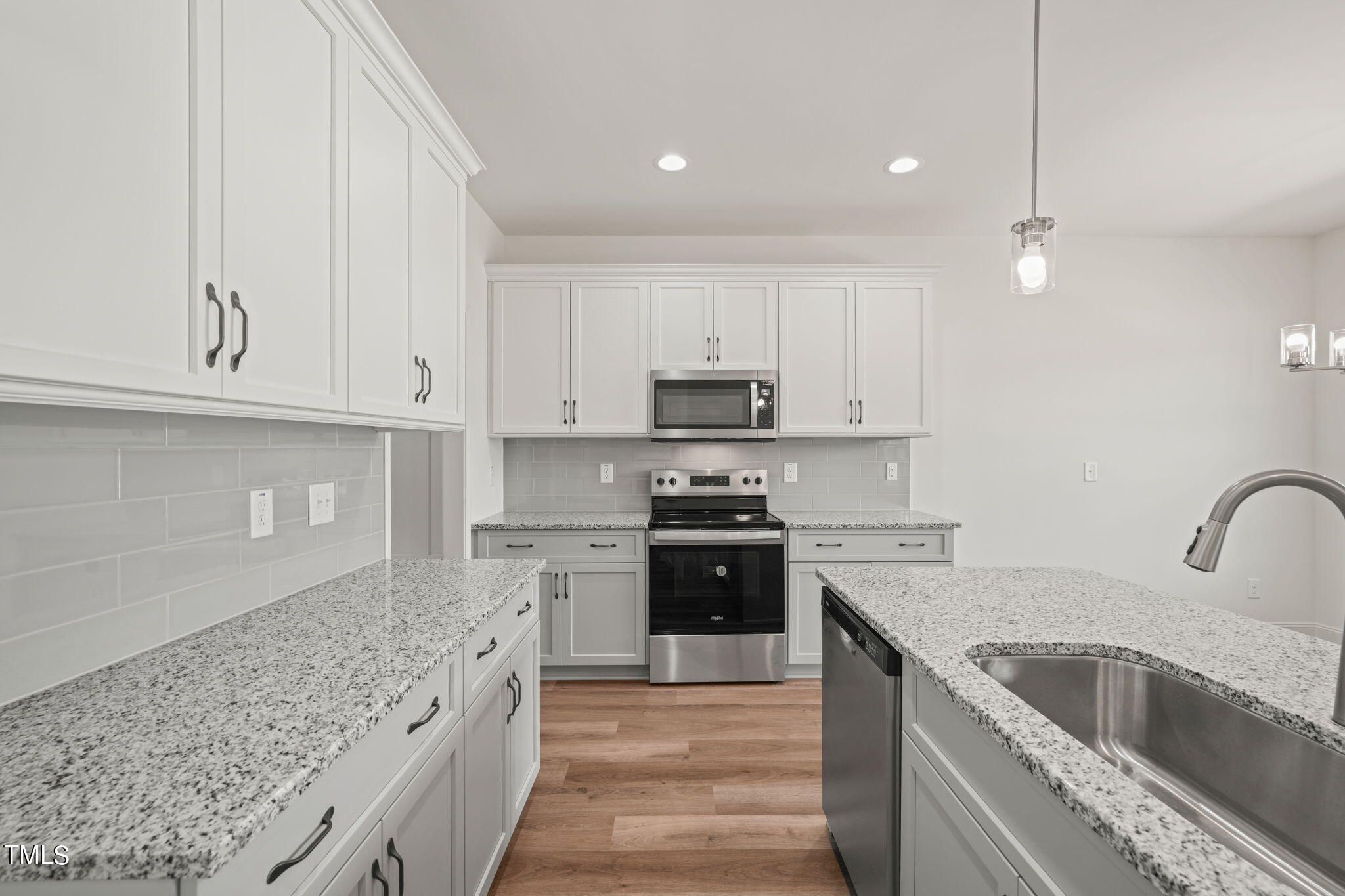 a kitchen with a sink stove and cabinets