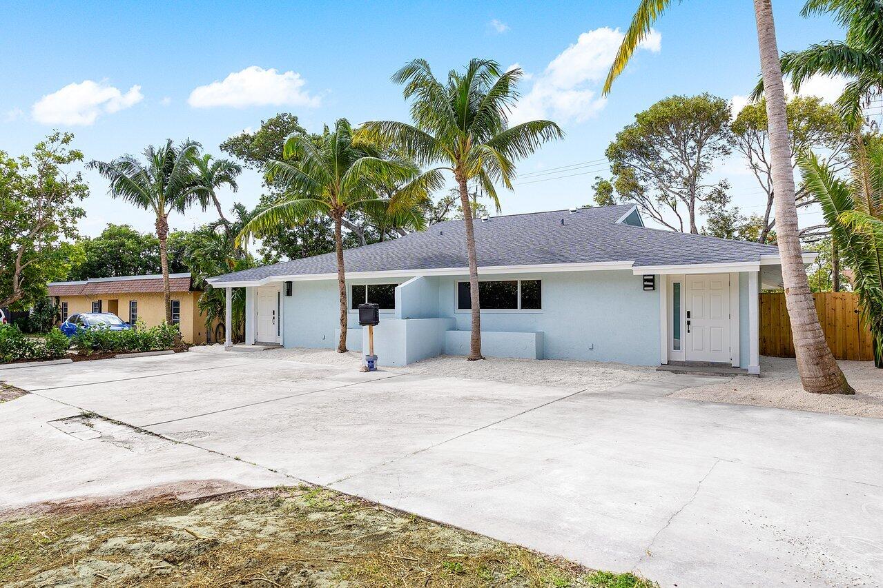 a house with palm tree in front of it