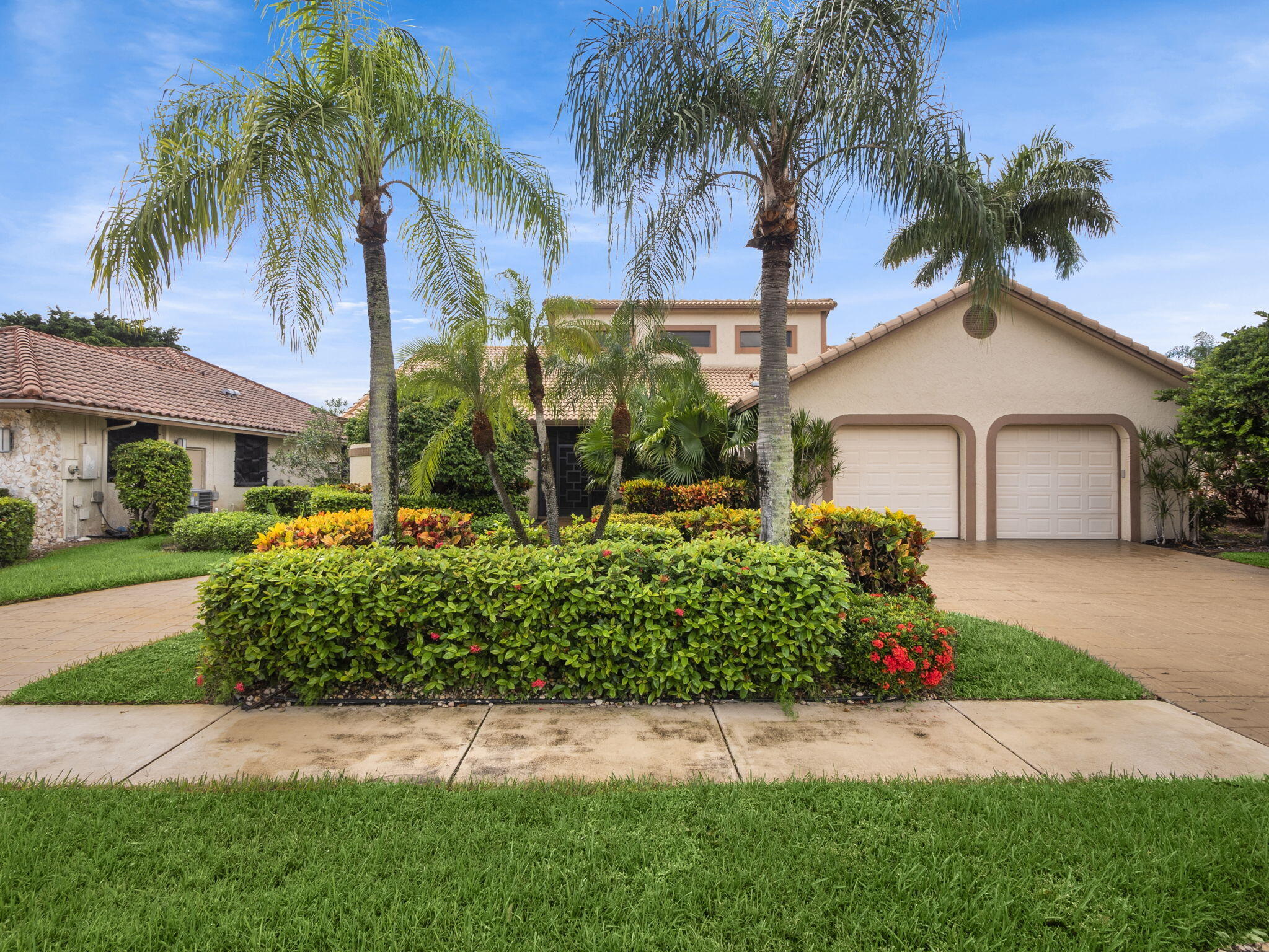 a front view of a house with a garden