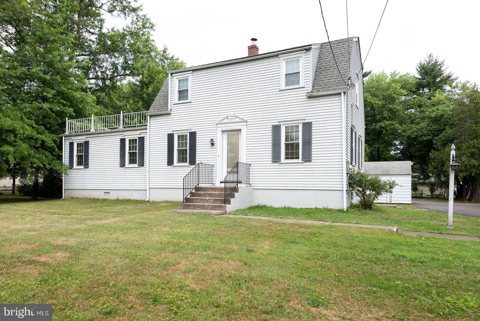 a view of a house with a yard and sitting area