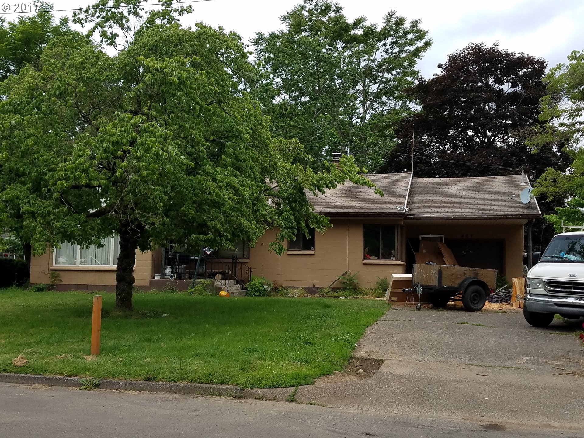 a view of a car parked in front of house with a yard