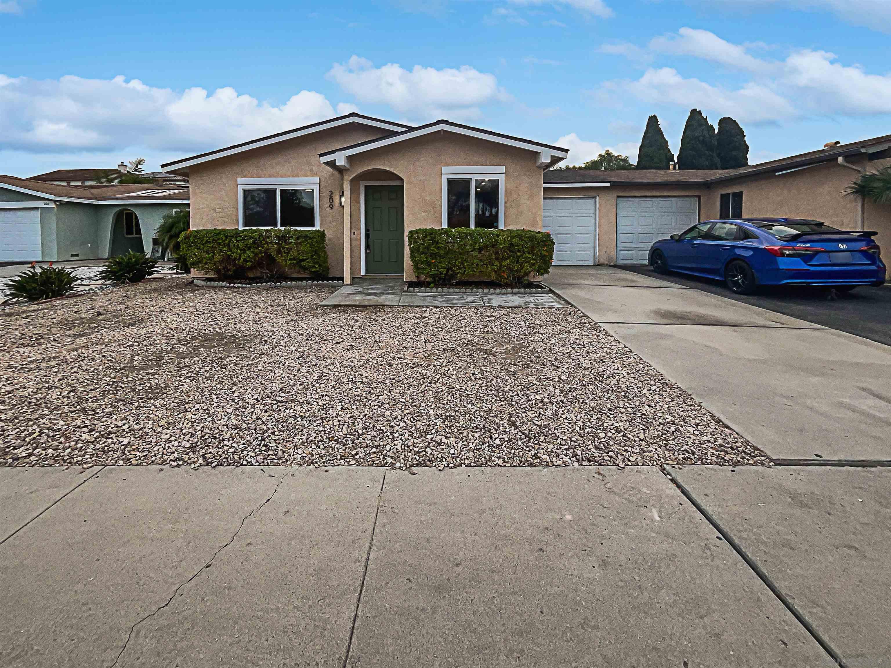 a front view of a house with a garden