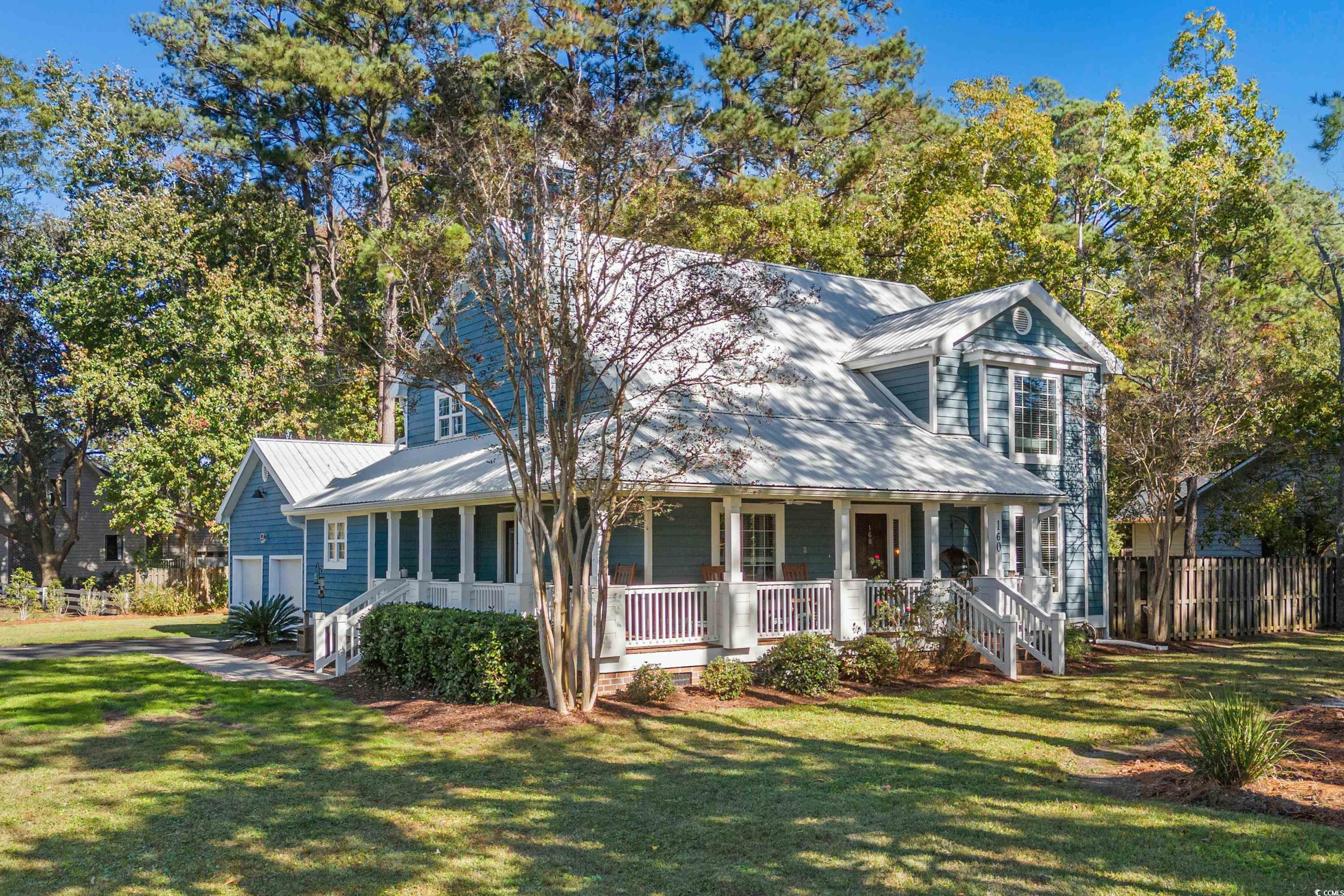 View of front facade featuring a porch, a garage,