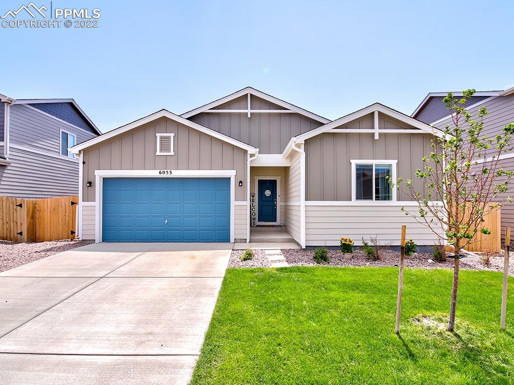 a front view of a house with a yard and garage