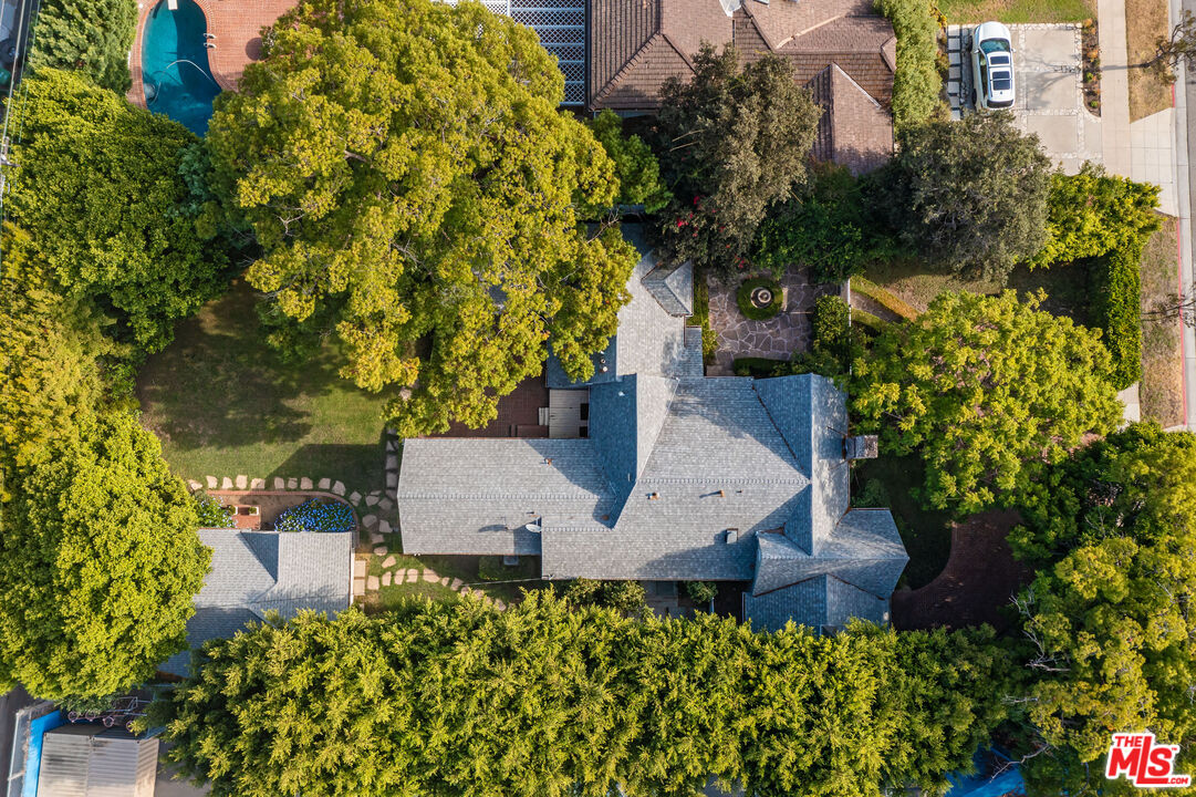 an aerial view of a house with a yard