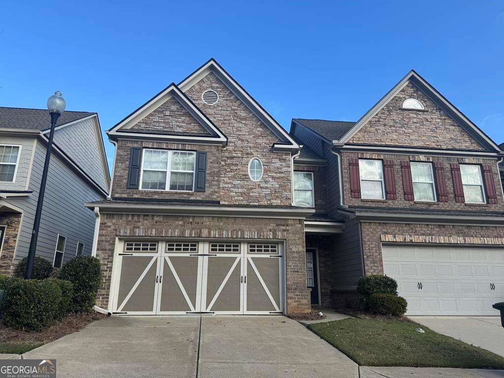 a front view of a house with garage