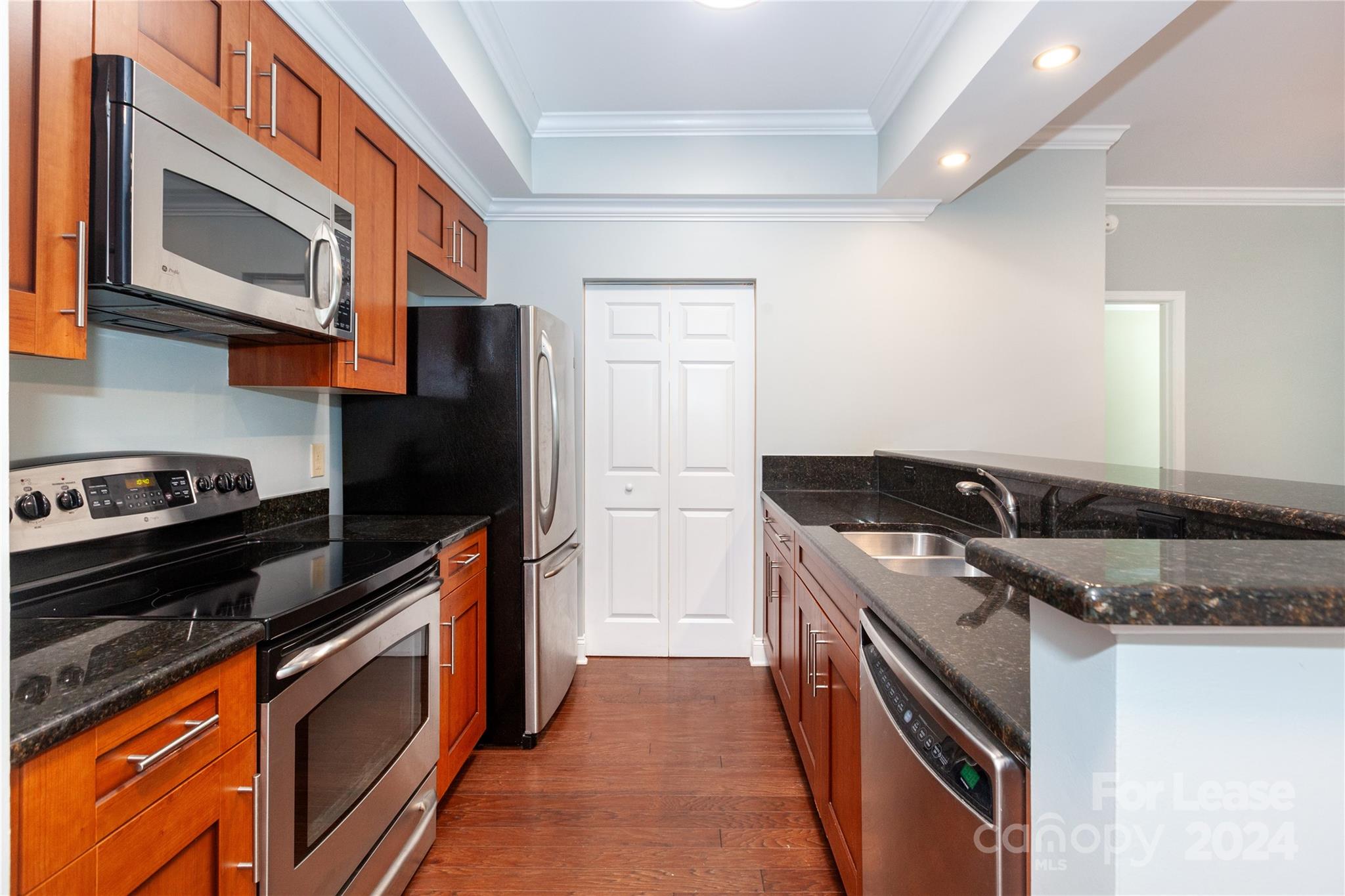 a kitchen with stainless steel appliances granite countertop a stove and a microwave