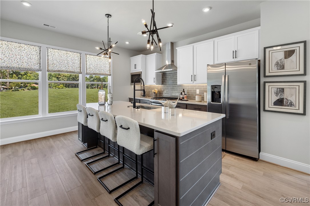 a kitchen with kitchen island a counter appliances a sink and cabinets