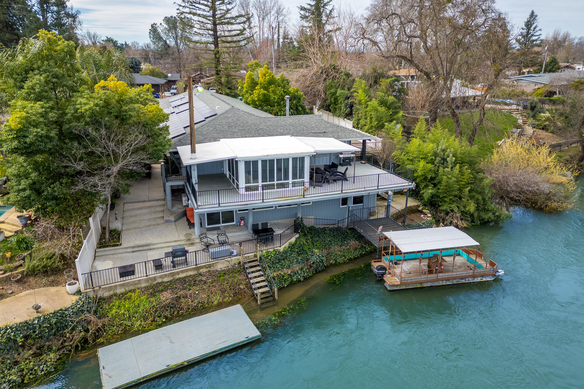 an aerial view of a house with roof deck outdoor seating space and yard