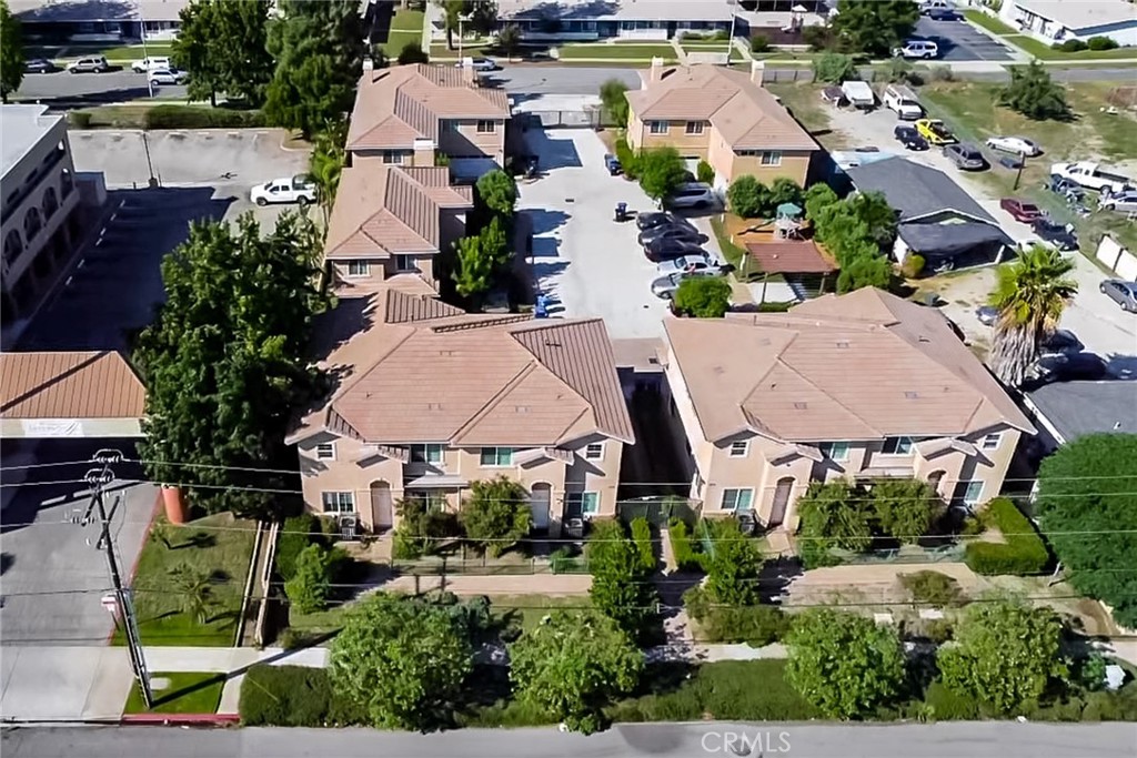 an aerial view of multiple houses with yard