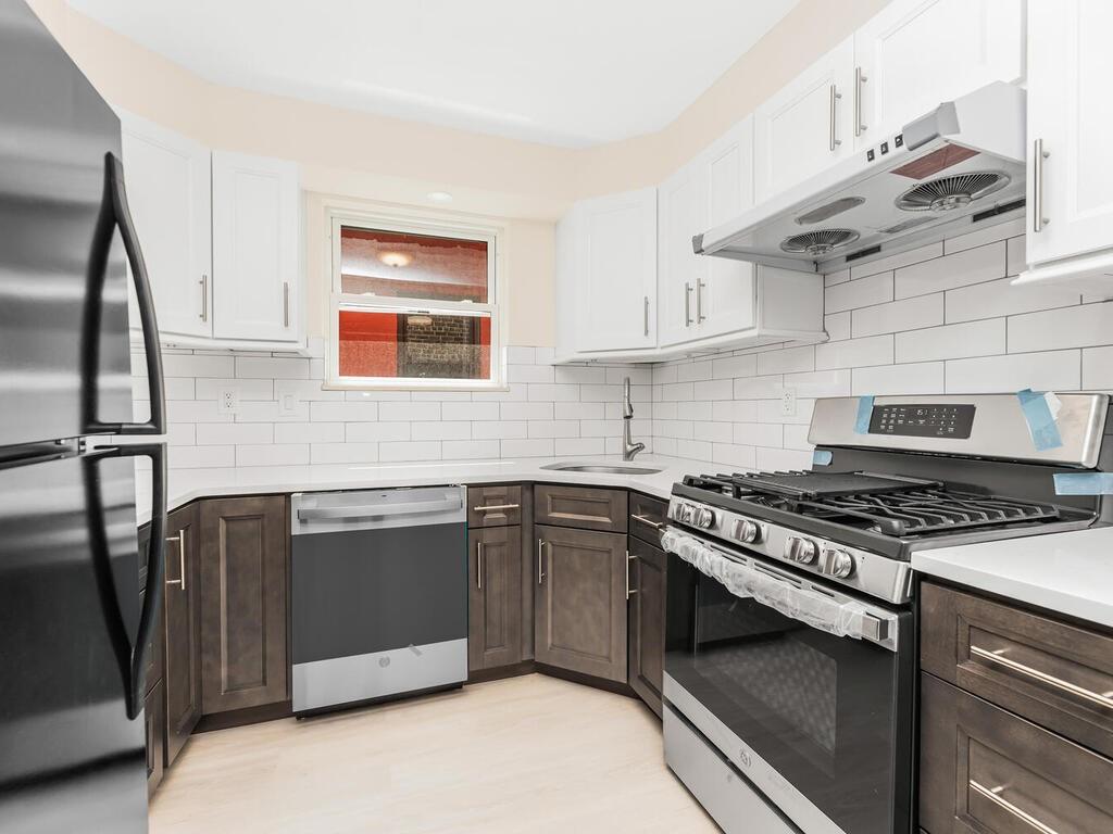 a kitchen with stainless steel appliances granite countertop a stove and a sink