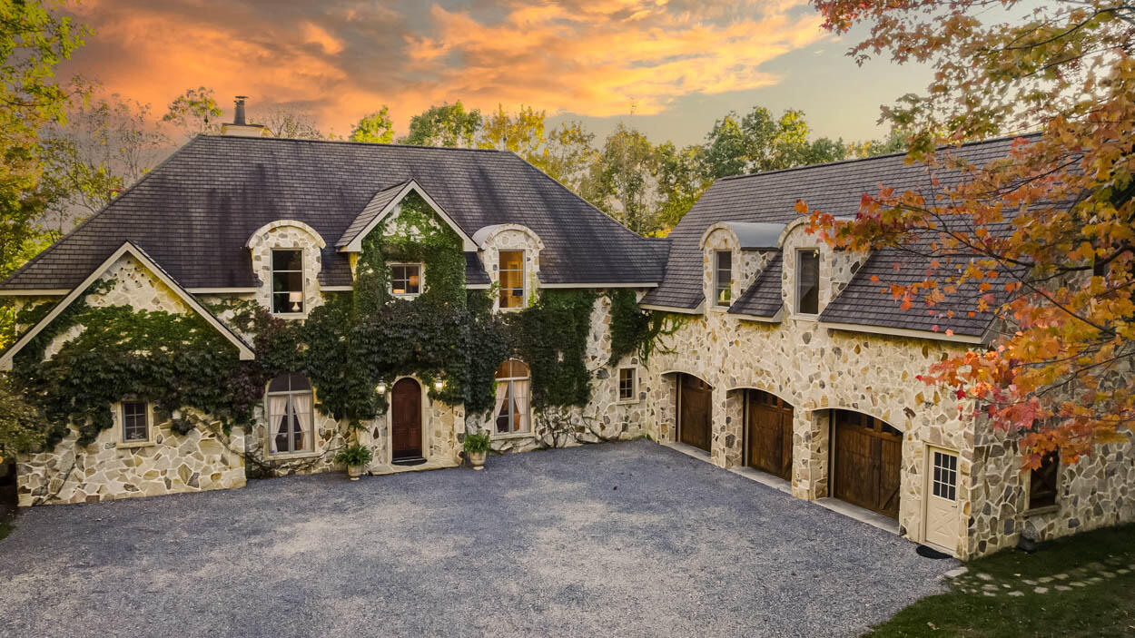 a aerial view of a house with a yard and garage