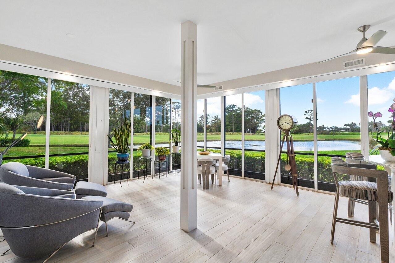 a living room with couch and a floor to ceiling window