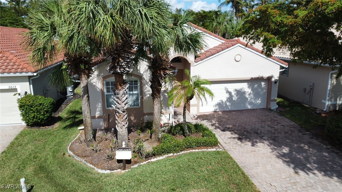 a view of a house with a yard and potted plants