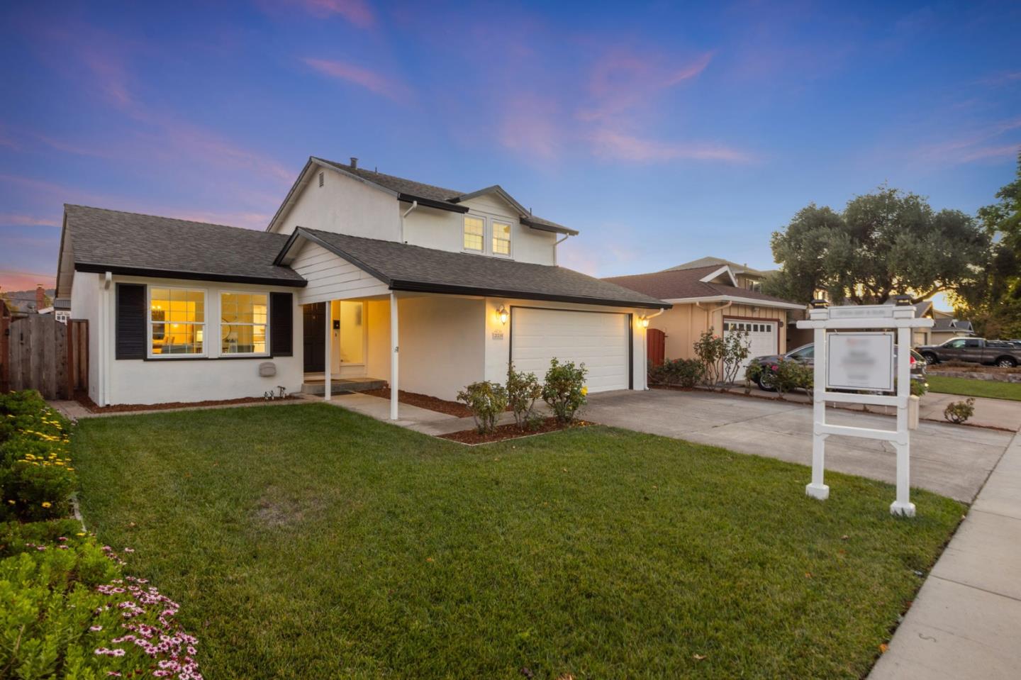 a view of a house with a backyard and a patio