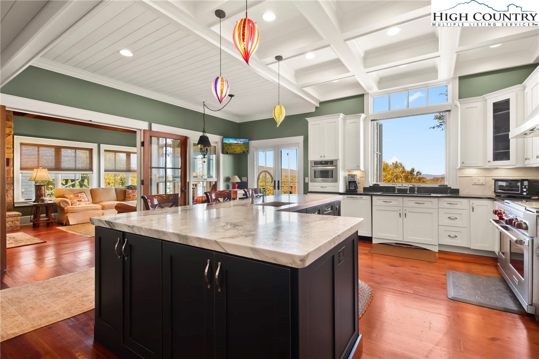 a kitchen with lots of counter space and painting on the wall