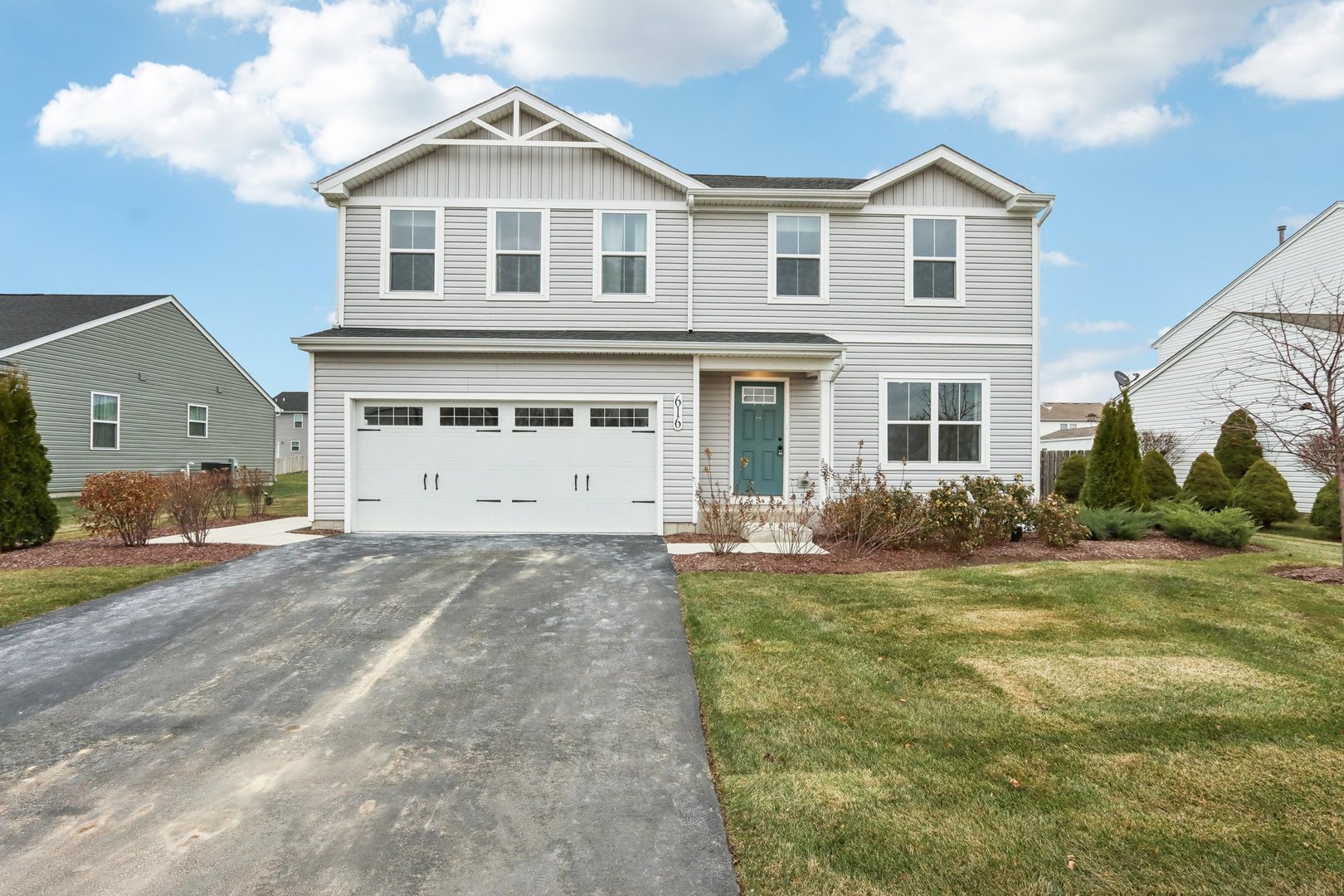 a front view of a house with a yard and garage