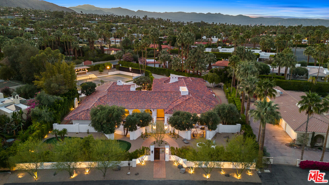 an aerial view of residential houses with outdoor space and river