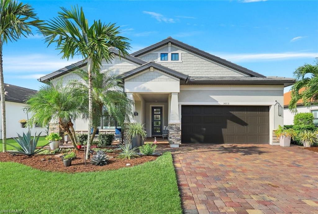 a front view of a house with a yard and palm trees