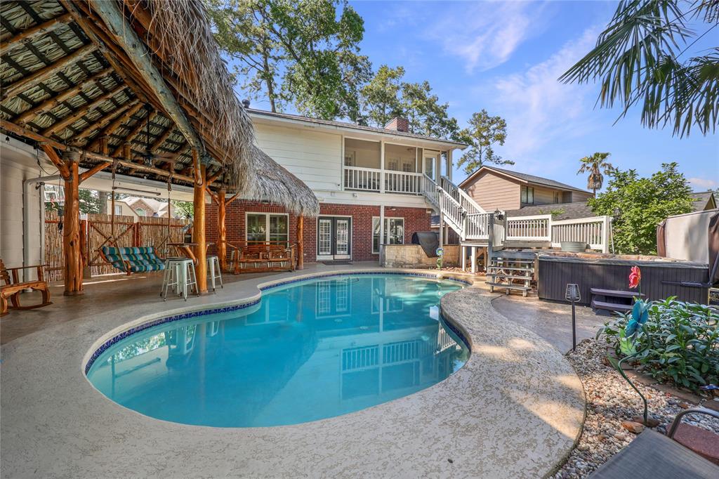 a view of a house with a swimming pool and sitting area