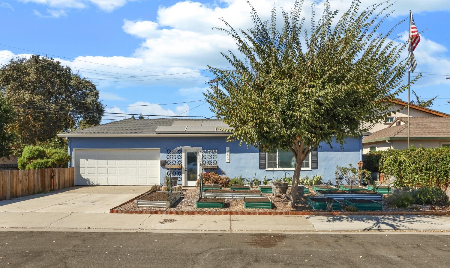 a front view of a house with garden