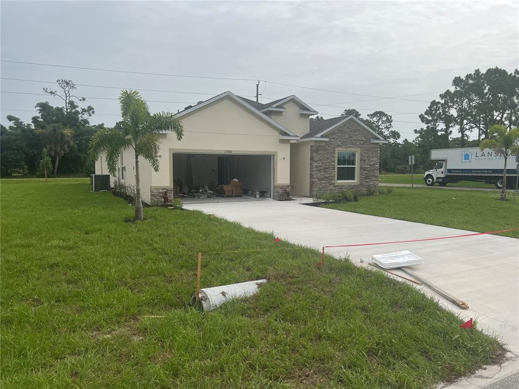 a front view of a house with a yard and trees