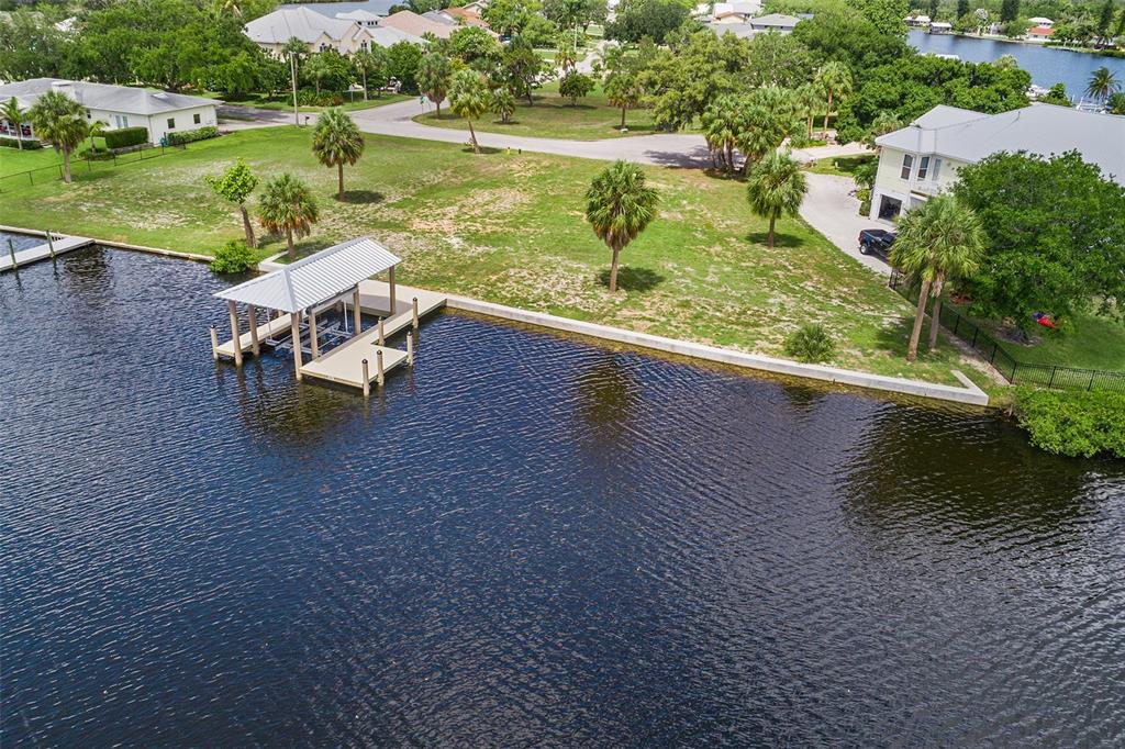 an aerial view of a house with a yard and lake view