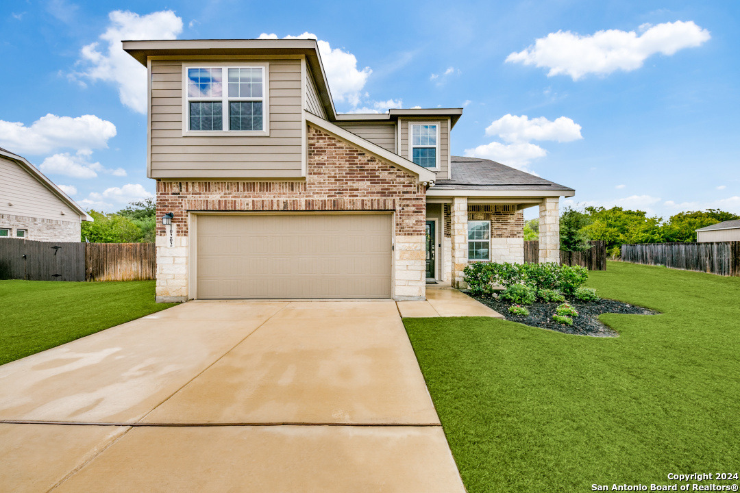 a front view of a house with a yard