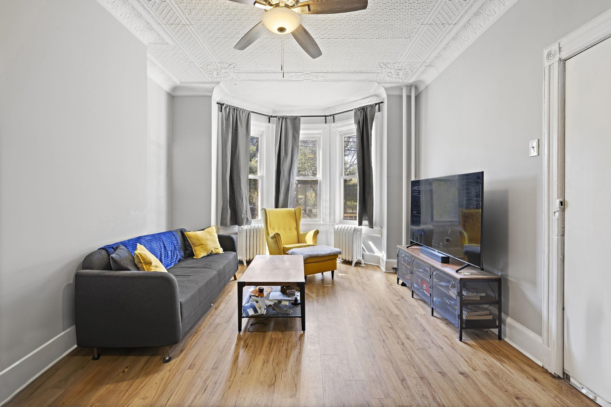 a living room with furniture and a flat screen tv