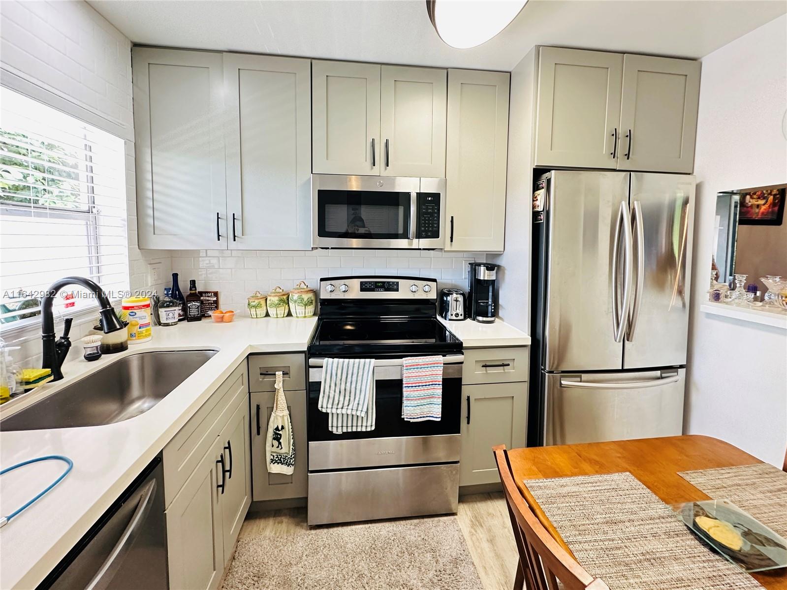 a kitchen with a refrigerator stove and sink