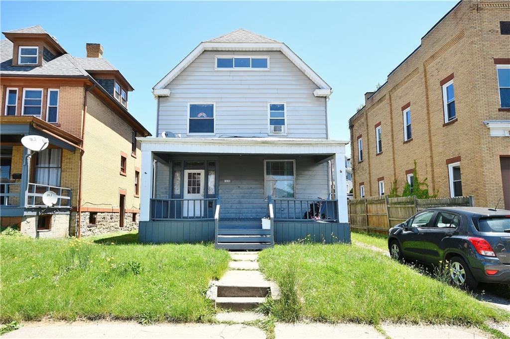 a front view of a house with a yard