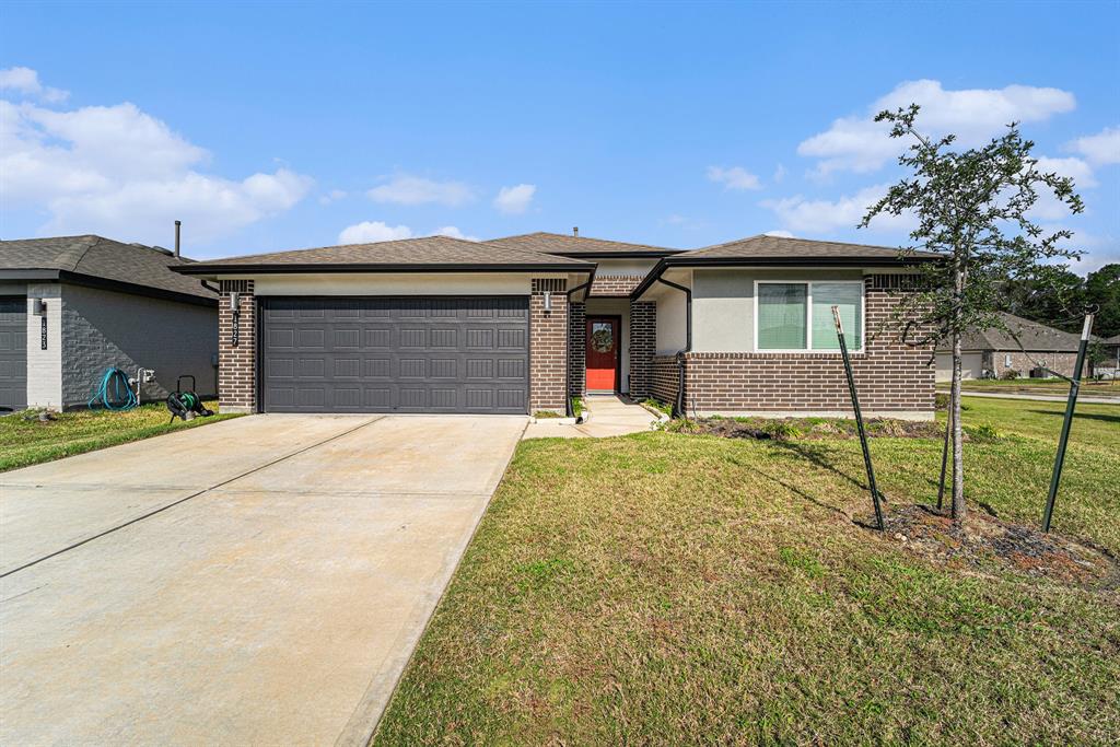 a front view of a house with a yard and garage