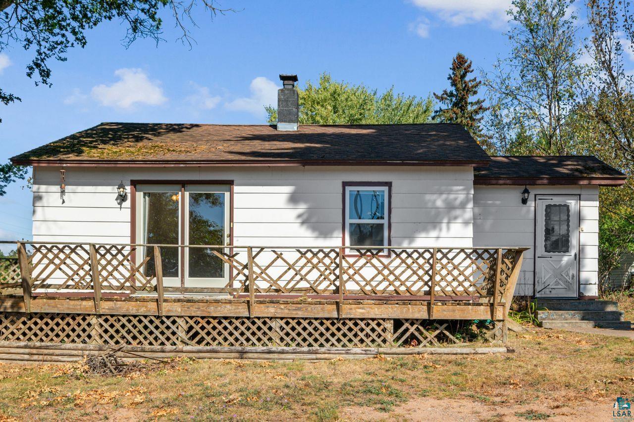 Rear view of house with a wooden deck