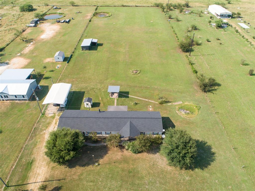 an aerial view of residential houses with outdoor space