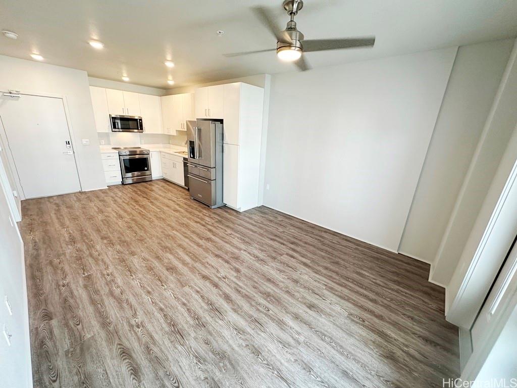 a view of kitchen with refrigerator microwave and cabinets