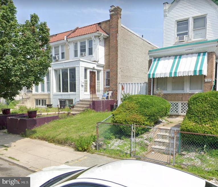 a front view of a house with a yard and plants