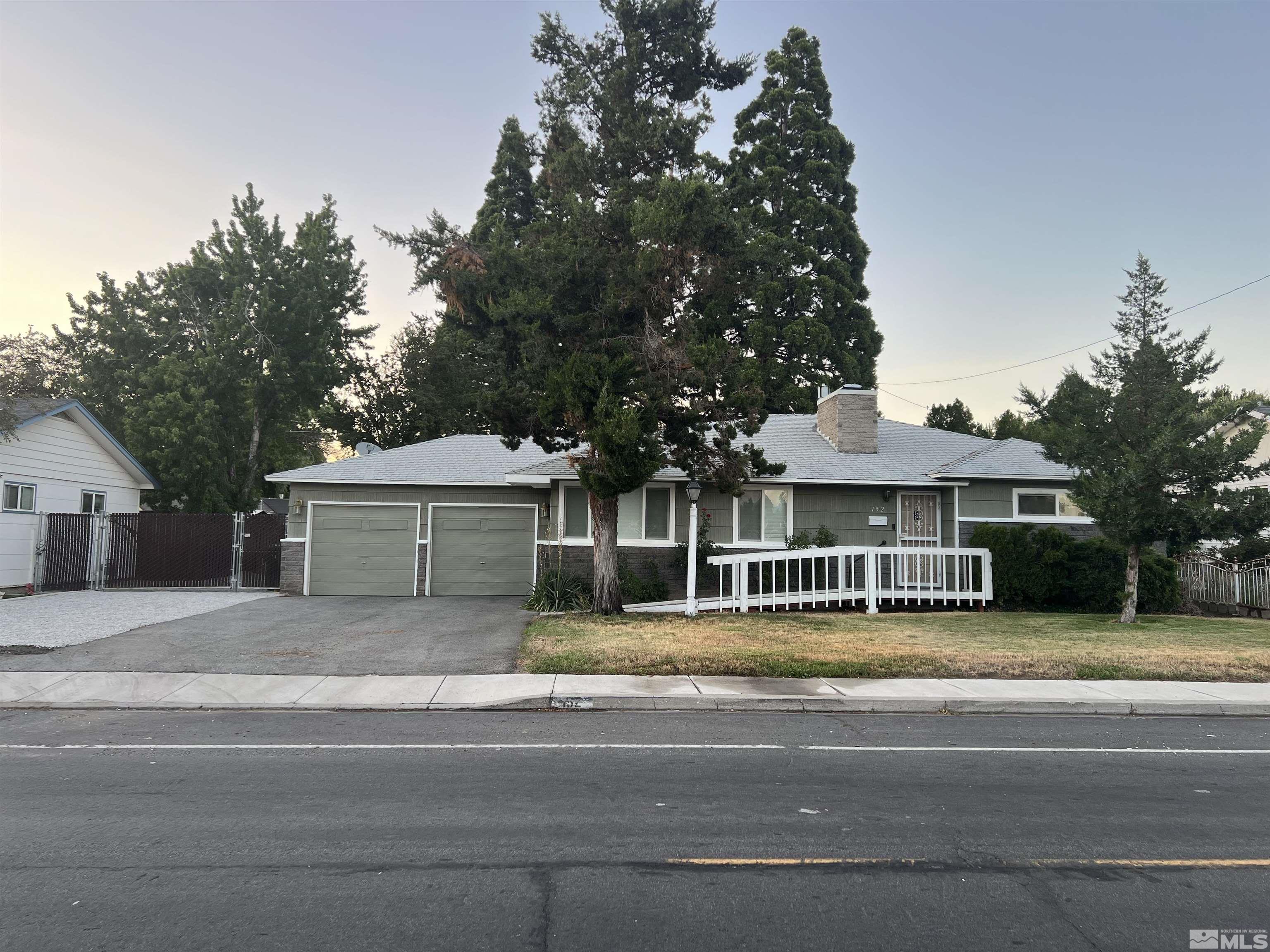 a front view of a house with a garden and a yard