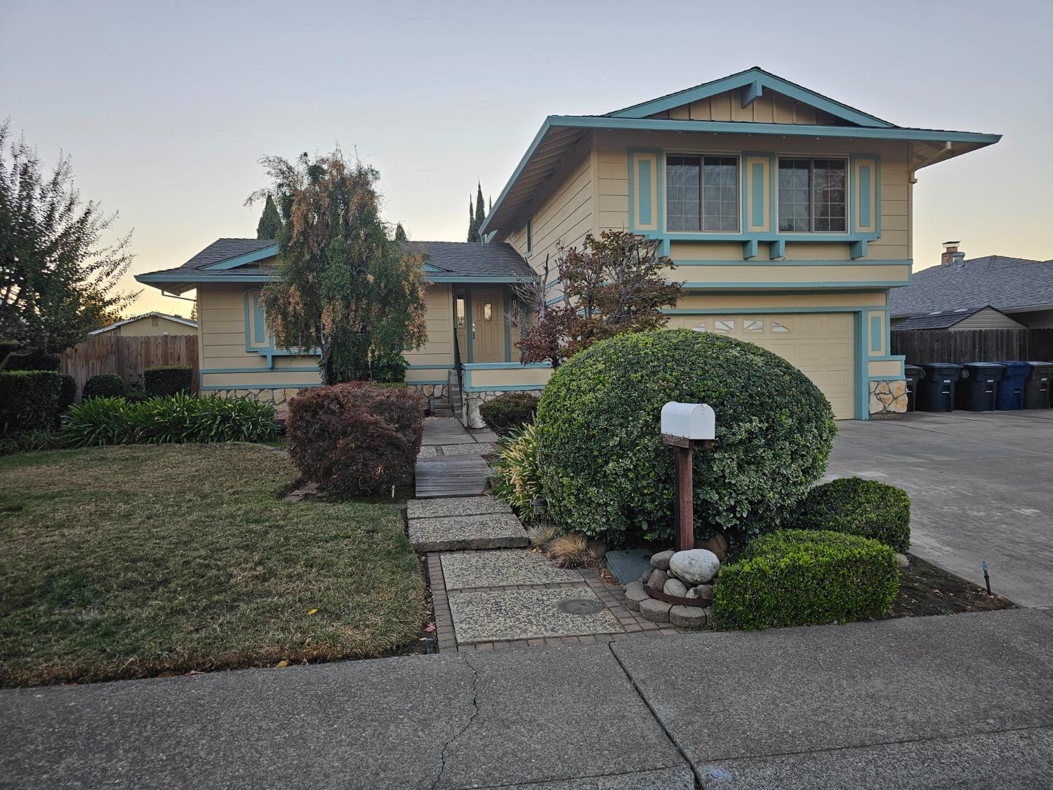 a front view of a house with a garden