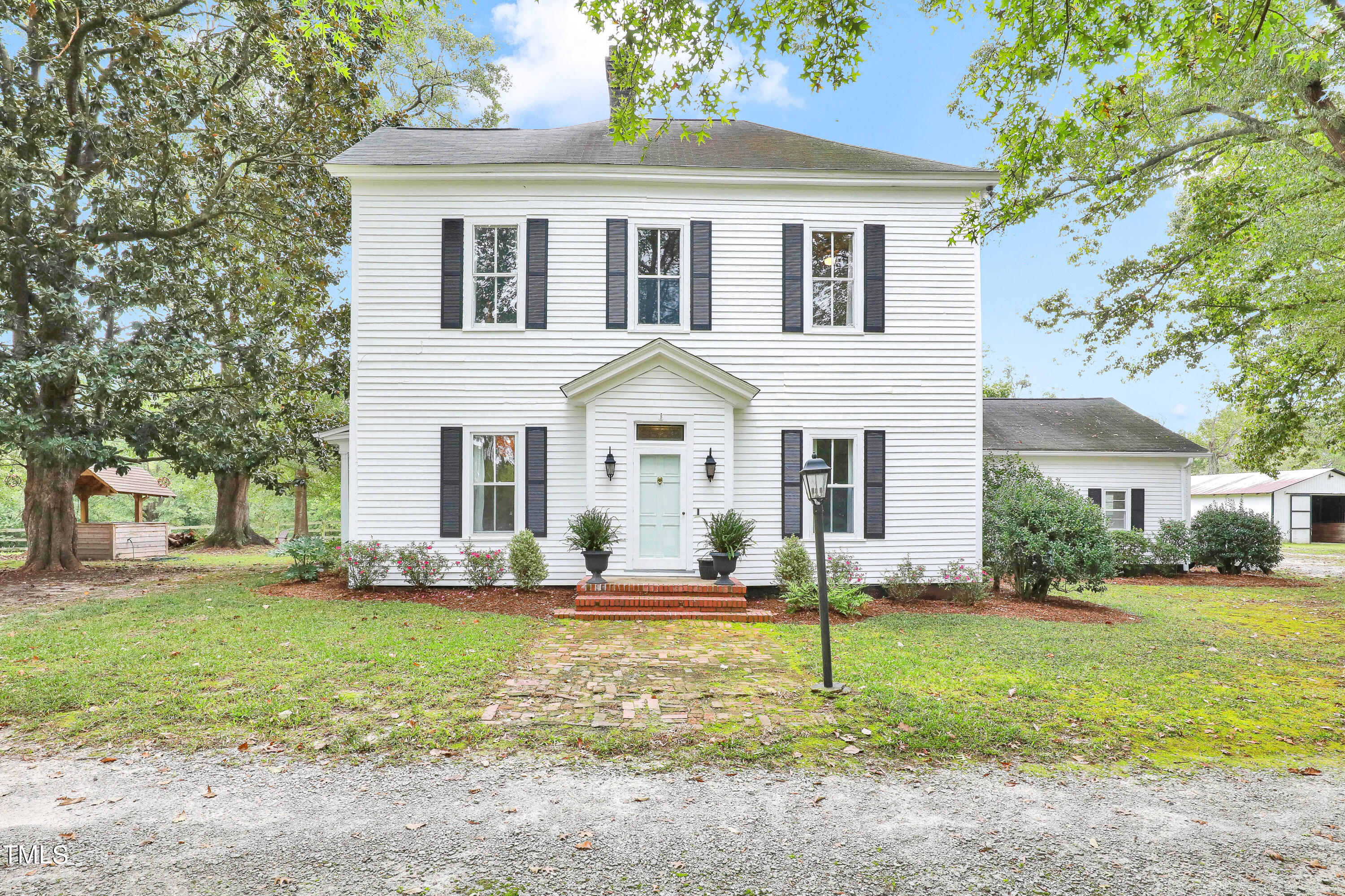 a front view of house with yard and green space