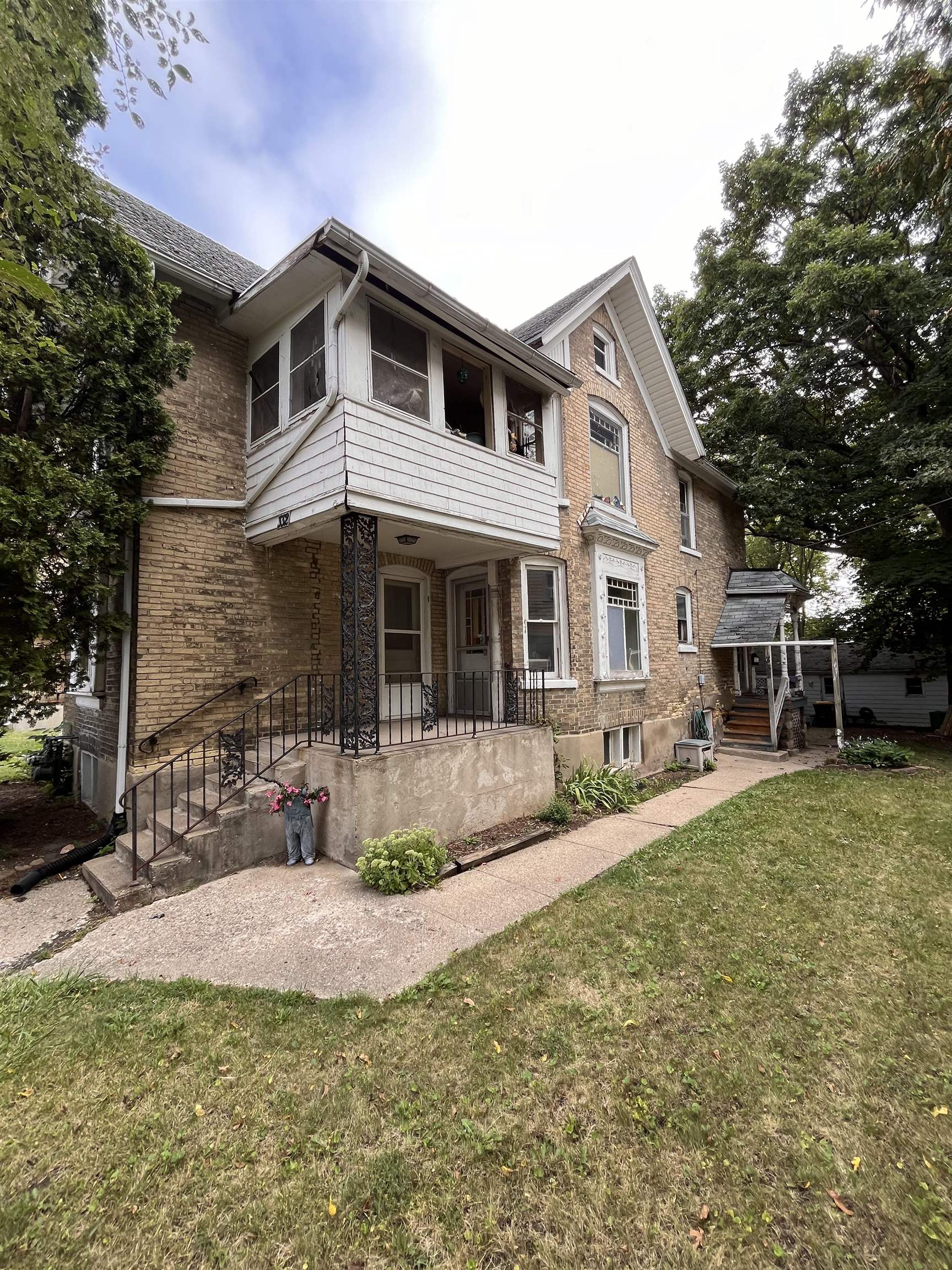 a front view of a house with a yard and porch