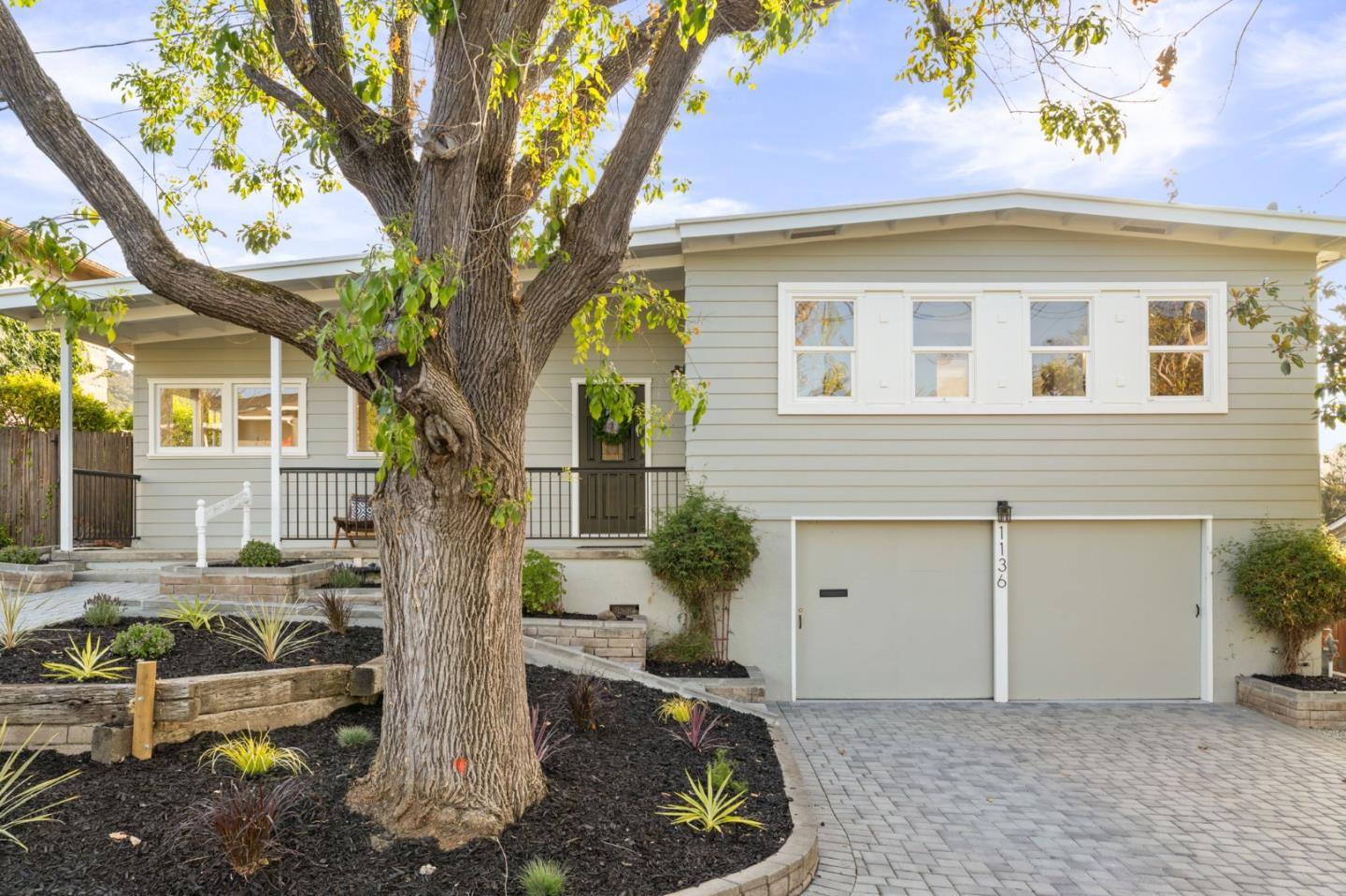 a front view of a house with garden