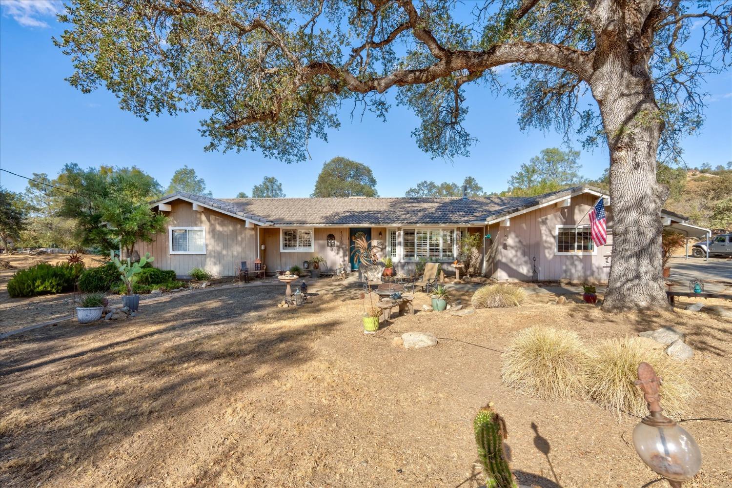 a view of a house with yard and sitting area