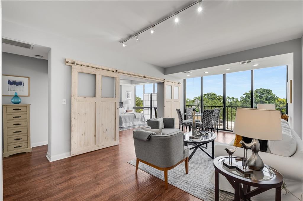 a living room with furniture a large window and a table