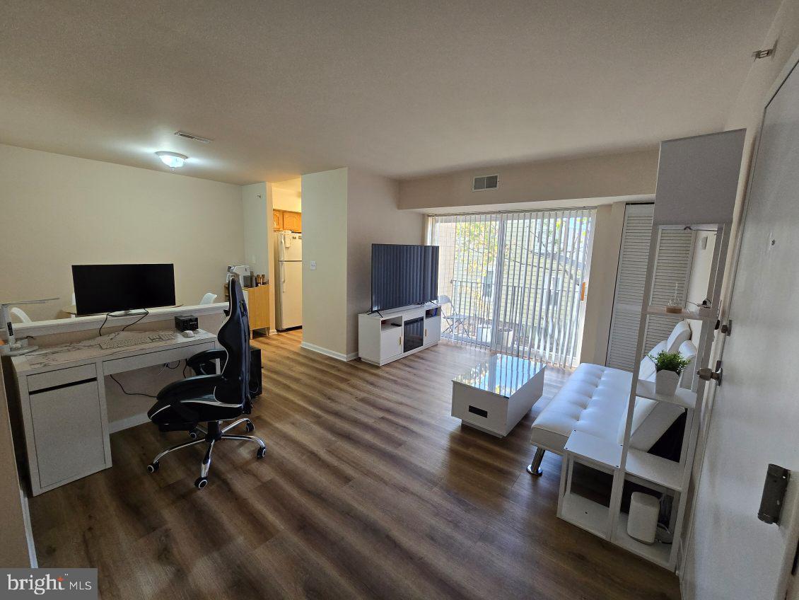 a view of a livingroom with workspace and a window